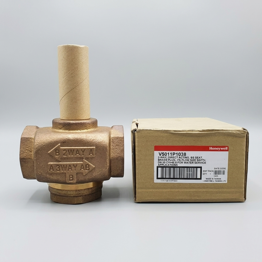 Front view of a genuine Honeywell V5011P1038 2-inch brass linear glove valve with cast flow indicators, positioned next to its official white product box, isolated against a uniform light gray background.